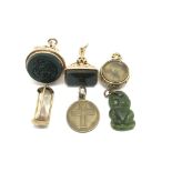 A collection of 9ct gold charms to include a fob,