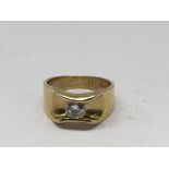 A small 18k gold ring set with either a white sapp