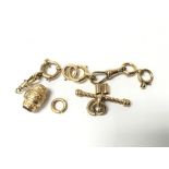 A collection of gold links and a barrel charm, etc