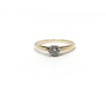 A 9ct gold ring set with a diamond, total weight a