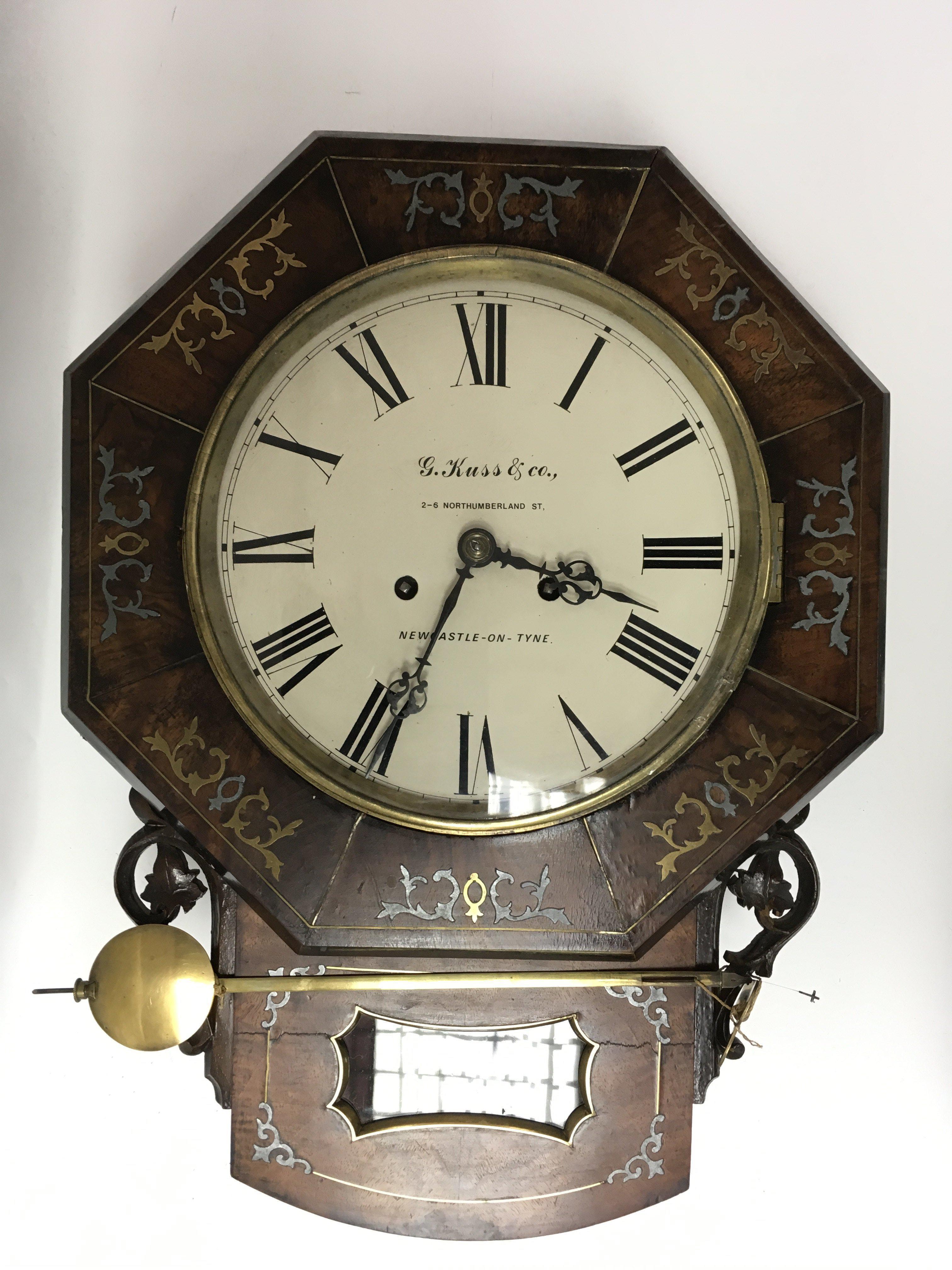 A 19th century wall clock with brass and pewter in