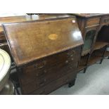 An Edwardian mahogany inlaid bureau the fall front