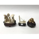 An ivory netsuke together with a pair of ivory car