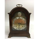 An oak mantle clock by The Alexander Clock Co., th