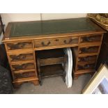 A modern Yew wood pedestal desk with a leather lined top and a matching side table. (2)