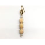 A 9ct gold fine chain and pendant with a pillar of
