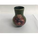 A small moorcroft vase decorated with hibiscus on
