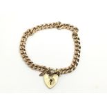 A 9ct gold bracelet with heart shaped padlock clas