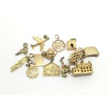 A collection on thirteen 9ct gold charms, to inclu