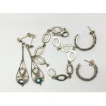 A pair of elongated silver and blue stone earrings
