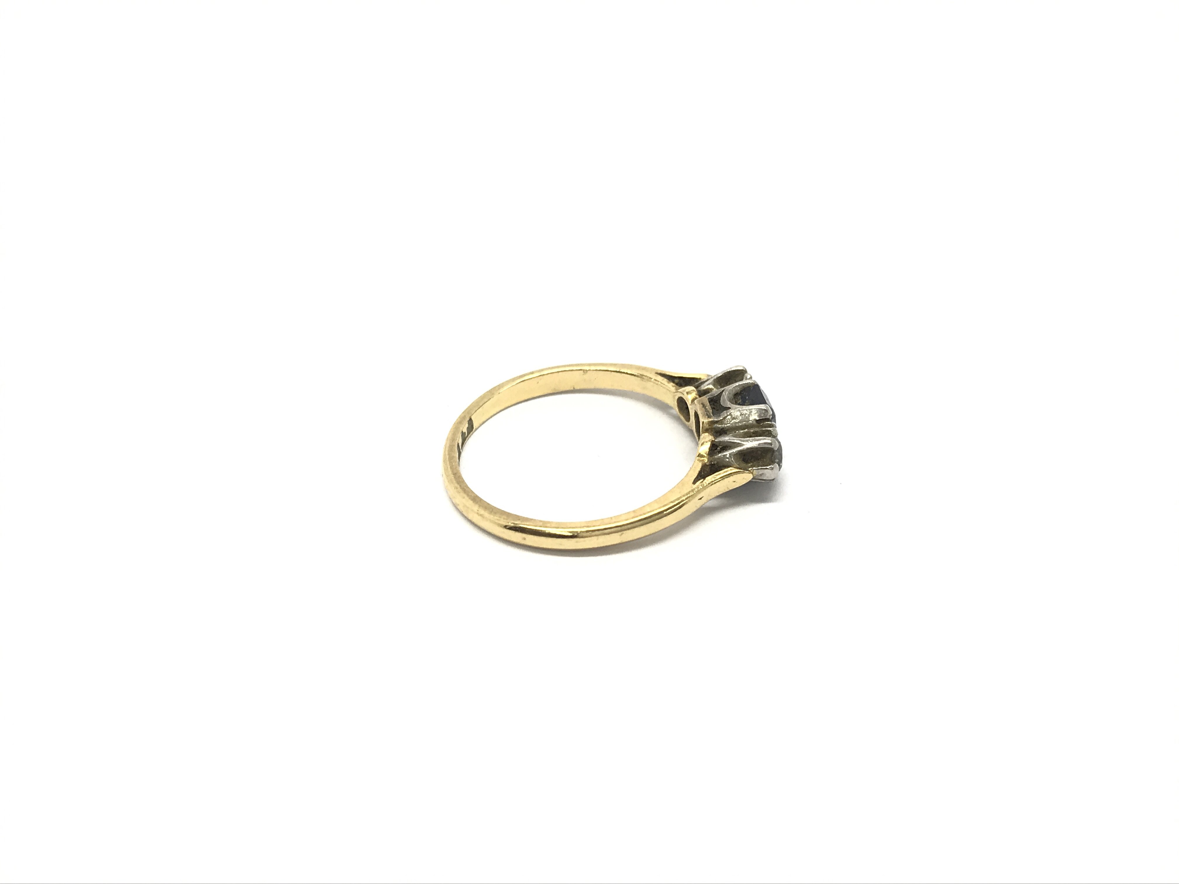 A ladies 18ct gold ring set with a central sapphir - Image 2 of 2