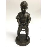 A similar contemporary bronzed figure of a boy hol