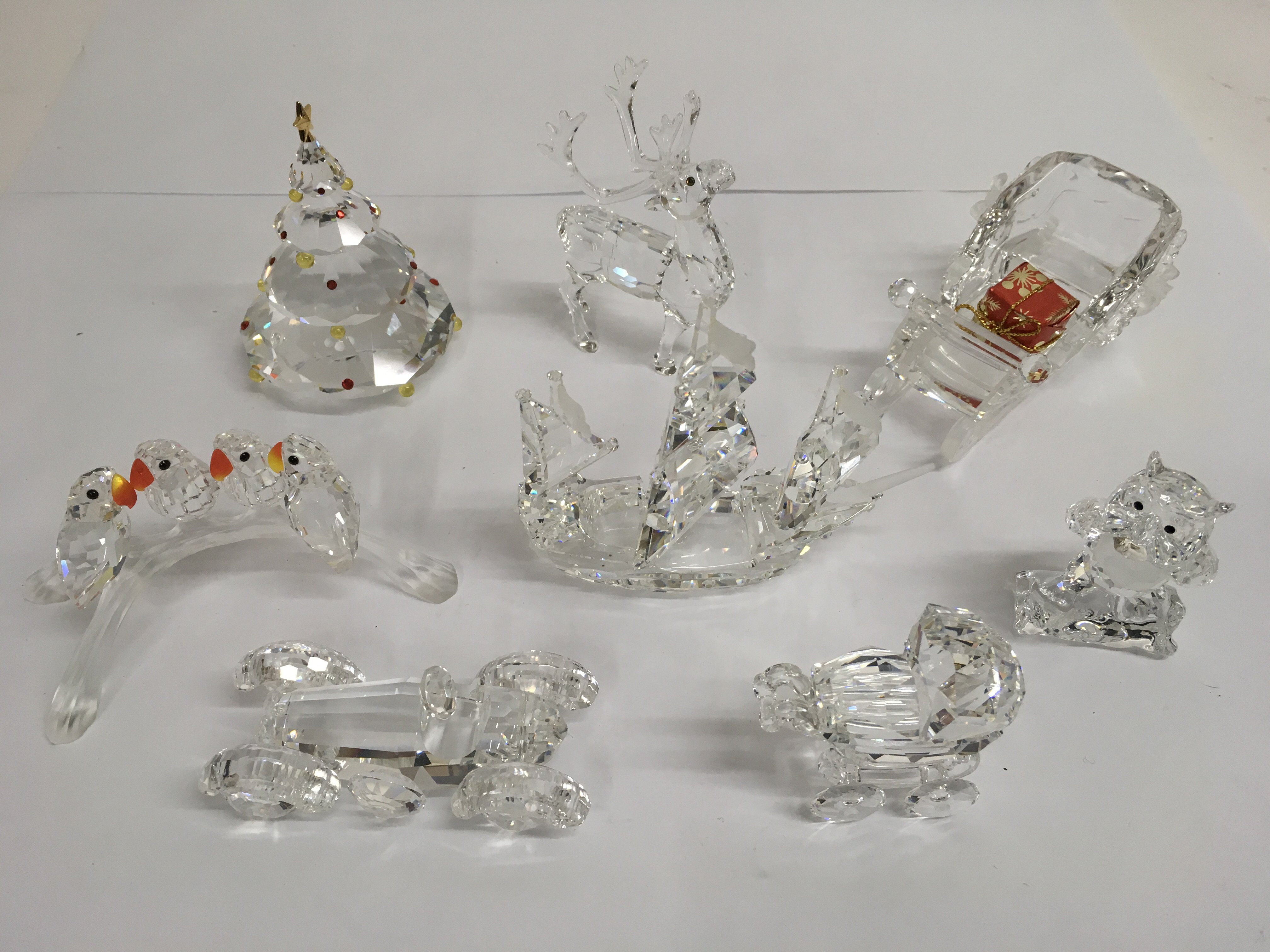 A small group of Swarovski crystal ornaments inclu