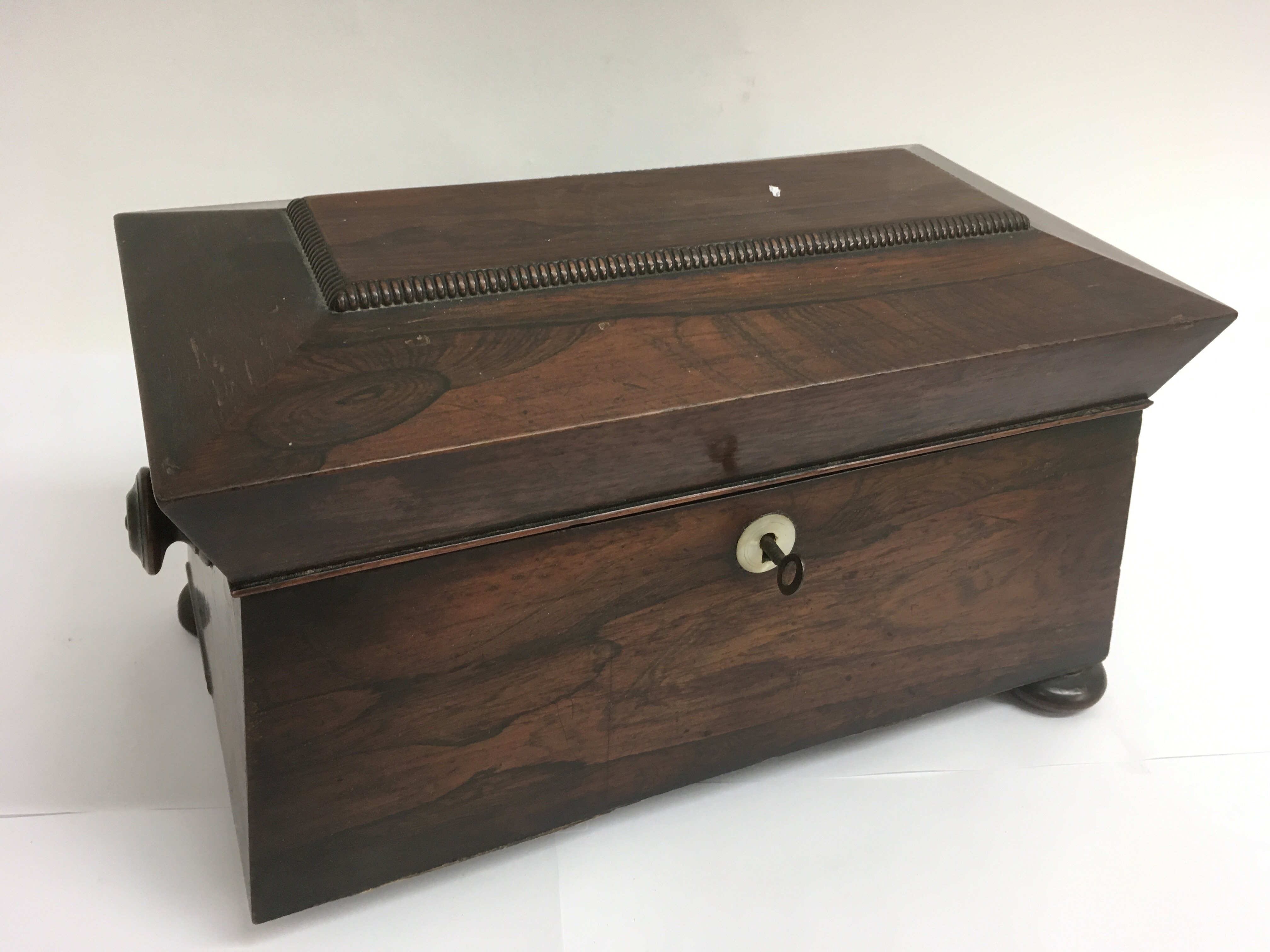 A rosewood tea caddy on bun feet.Approx 18x34cm, l