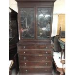 A George III secretaire bookcase with similar top, the base having four drawers. Measures approx