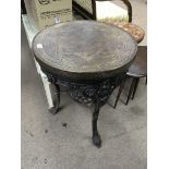 A cast iron Victorian pub table, with brass top. Measures approx 58cm across x 74cm tall.