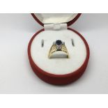 An 18ct gold ring with an emerald and a sapphire s