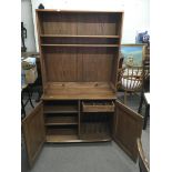 An Ercol dresser cabinet with two shelves and cupb