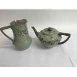 A macintyre tea pot and hot water jug decorated with foilage on a green ground