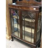 A mahogany double door display cabinet with glazed
