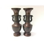 A pair of bronze Japanese twin handled vases. Meas