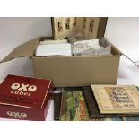 A collection of cigarette cards and stamps