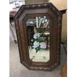 An oak framed mirror decorated with flowers. Appro