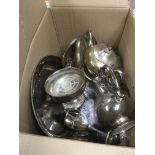 A box of various silver plated items.