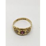 An 18ct gold ring set with small rubies and diamon