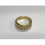 A 18ct gold ring inset with five diamonds size Q 7 .5 grams approx