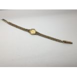 A lady's 9ct wristwatch on woven strap