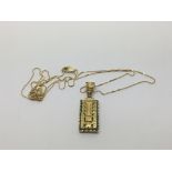 A gold ethnic pendant on a chain, approx 7.4g.