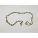 A 9ct gold pendant on chain set with a peridot, ap