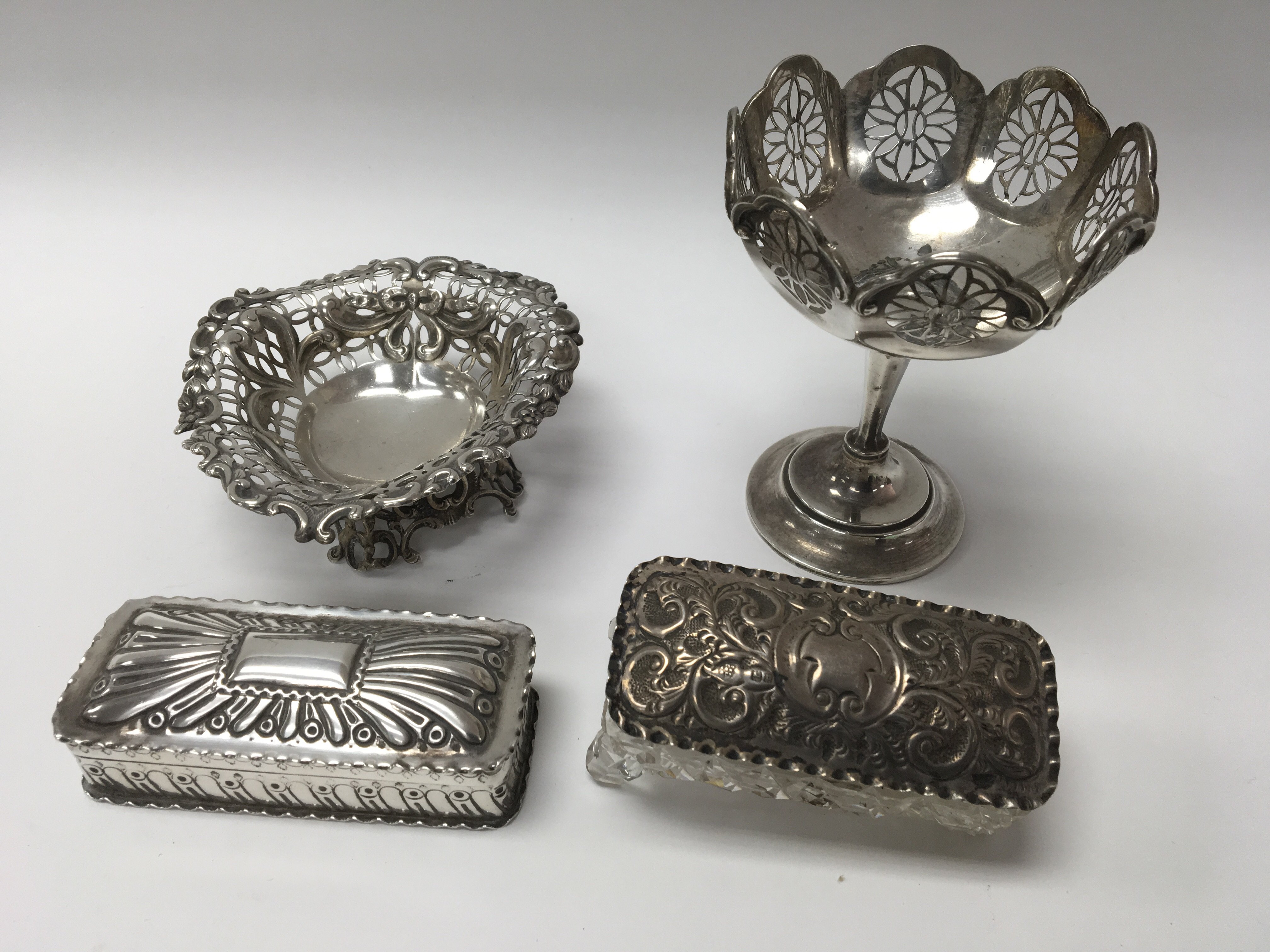 A collection of four items of silver heart shap di