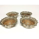 A Quality set of four William IV silver wine coasters with unusual orgional satinwood bases