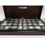 A collection of 30 wildlife silver ingots contained in a fitted case 1567 grams