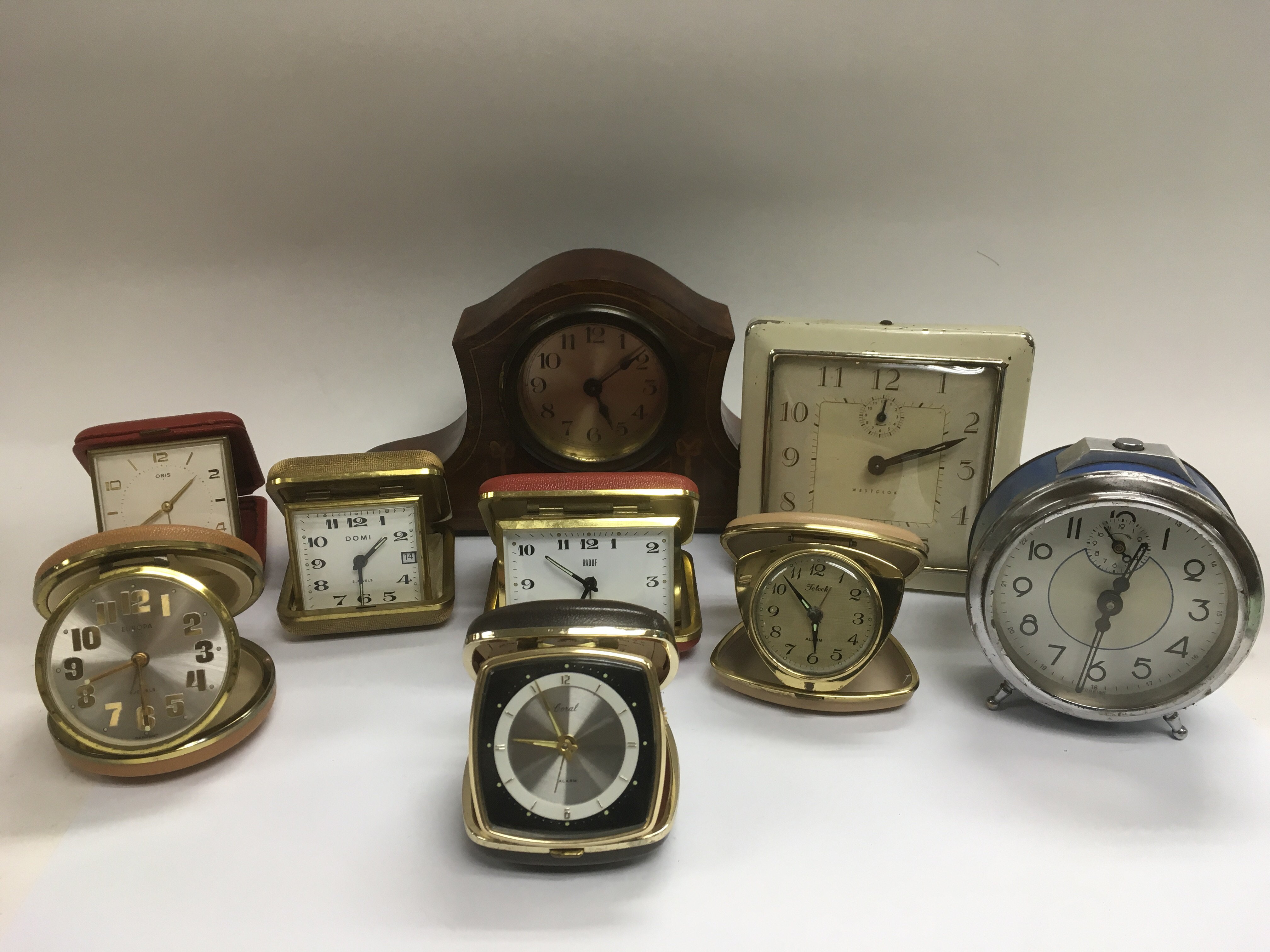 Eight vintage alarm clocks and an inlaid mantle cl