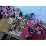 A box of various dolls including Barbie etc also including 2 Barbie cars and a horse