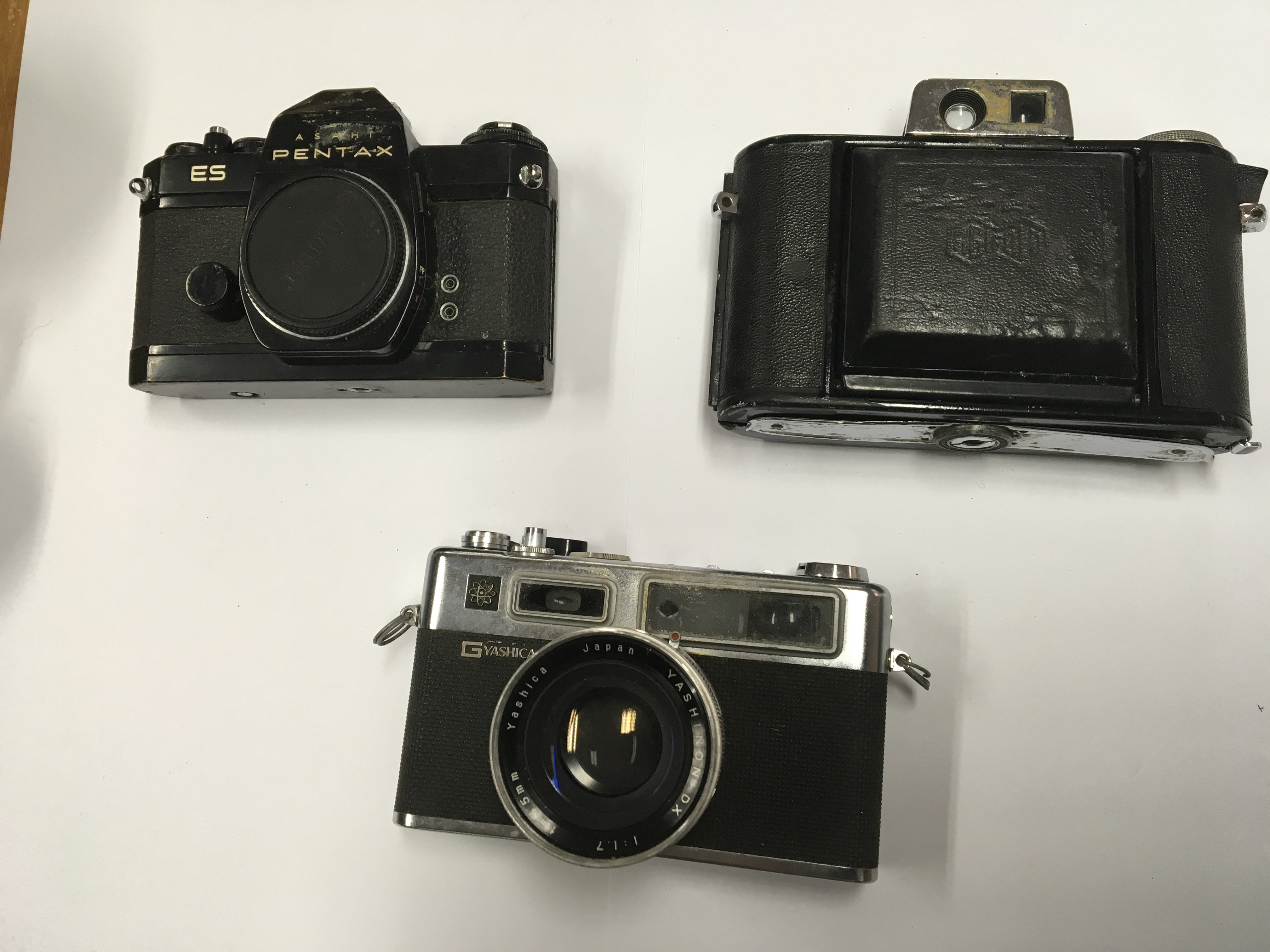 A group of three cameras to include a Pentax ES, Agricola camera and a Yashica Electro 35G camera