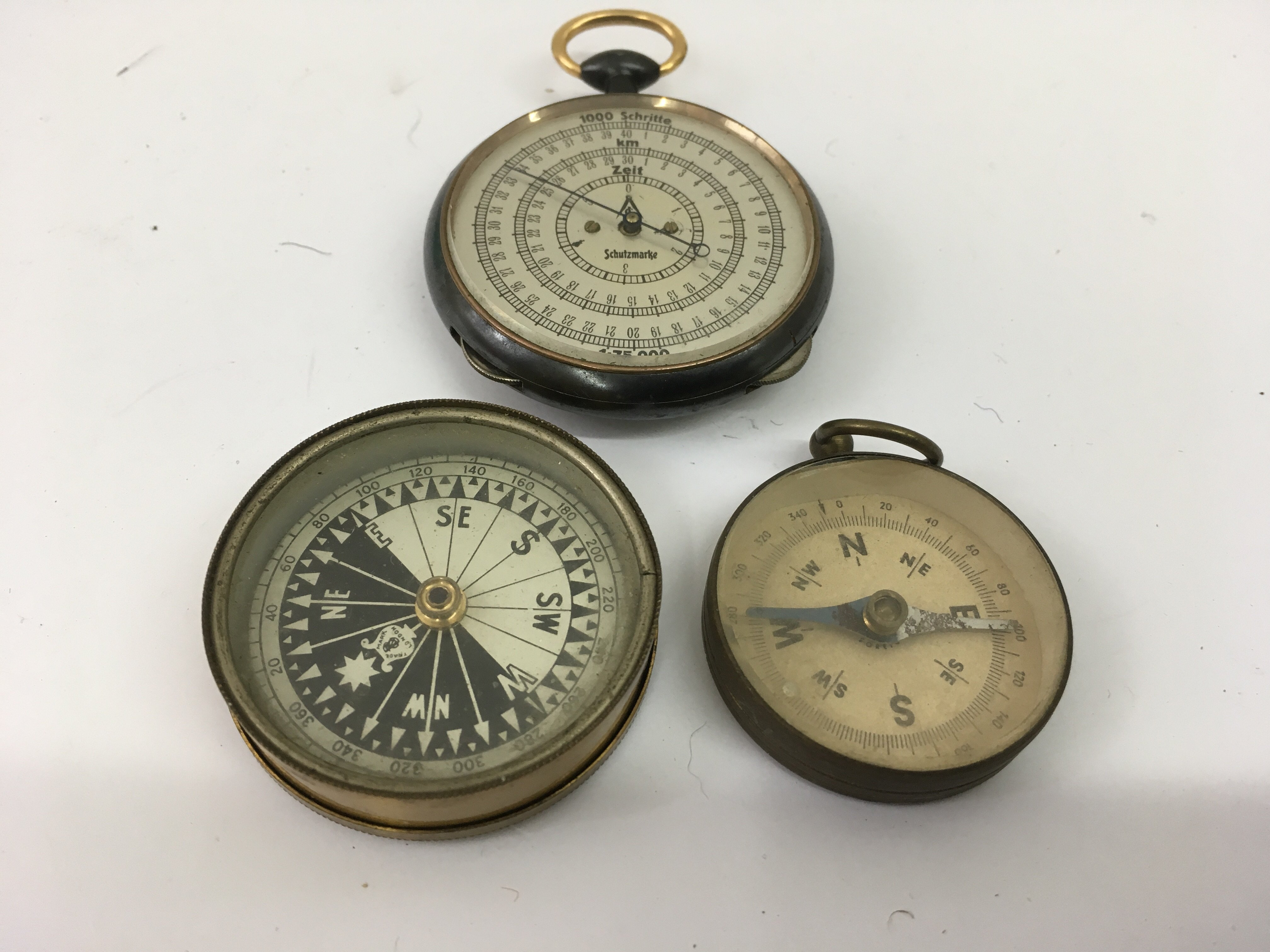 A German stopwatch and two pocket compasses