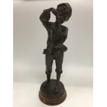 A French bronzed figure of a boy, signed to the ba