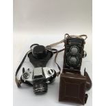 A leathercased Rolleiflex camera and German Thagee Exa IIB camera