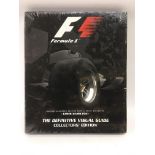 A sealed 'F1 The Definitive Visual Guide' hardback