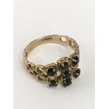 A 9ct gold openwork ring set with five sapphires.A