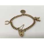 A 9ct gold link bracelet set with three horse char