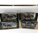 A collection of boxed 1:18 scale diecast vehicles