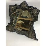 A large silver framed bevelled vanity mirror with