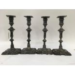 Four silver candlesticks of similar design with de