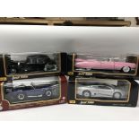 A collection of boxed 1:18 scale diecast vehicles