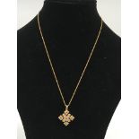 A gold cross set with ruby, diamond and sapphire c